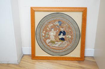 A 20th century Chinese framed embroidered figurative silk circular panel with a brocade border